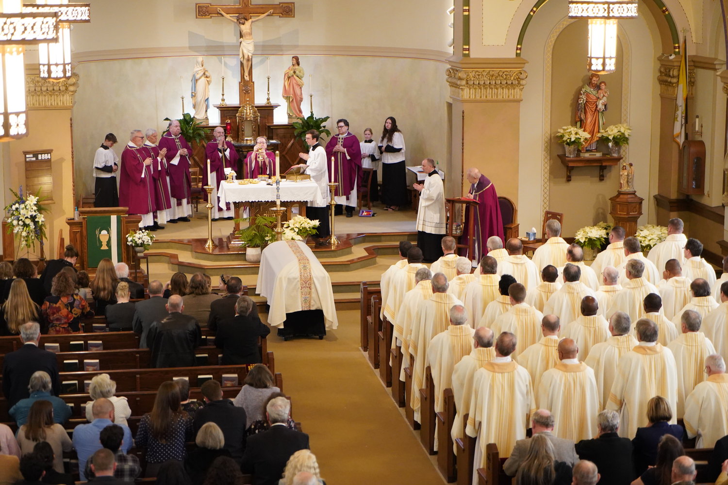Priests of the Jefferson City diocese chant the ancient “Salve Regina” (“Hail, Holy Queen”) prayer seeking the Blessed Mother’s intercession as Fr. John Groner’s earthly remains are carried out of Immaculate Conception Church in Jefferson City after his Funeral Mass on Jan. 16.